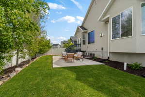 Fenced backyard with a patio area and outdoor seating