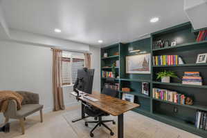 Office space featuring light colored carpet, built in features, and recessed lighting