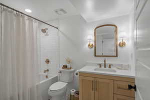 Bathroom with vanity and shower / bathtub combination with curtain