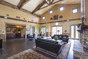 Living room with lofted ceiling and a wainscoted wall