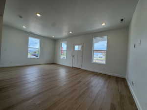Entrance foyer with a textured ceiling, recessed lighting, and light wood finished floors