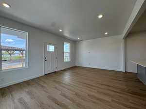 Foyer featuring recessed lighting, a textured ceiling, and light wood-style floors