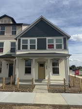 View of front of home with covered porch and stucco siding