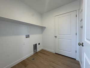 Laundry area featuring wood finished floors, washer hookup, and electric dryer hookup