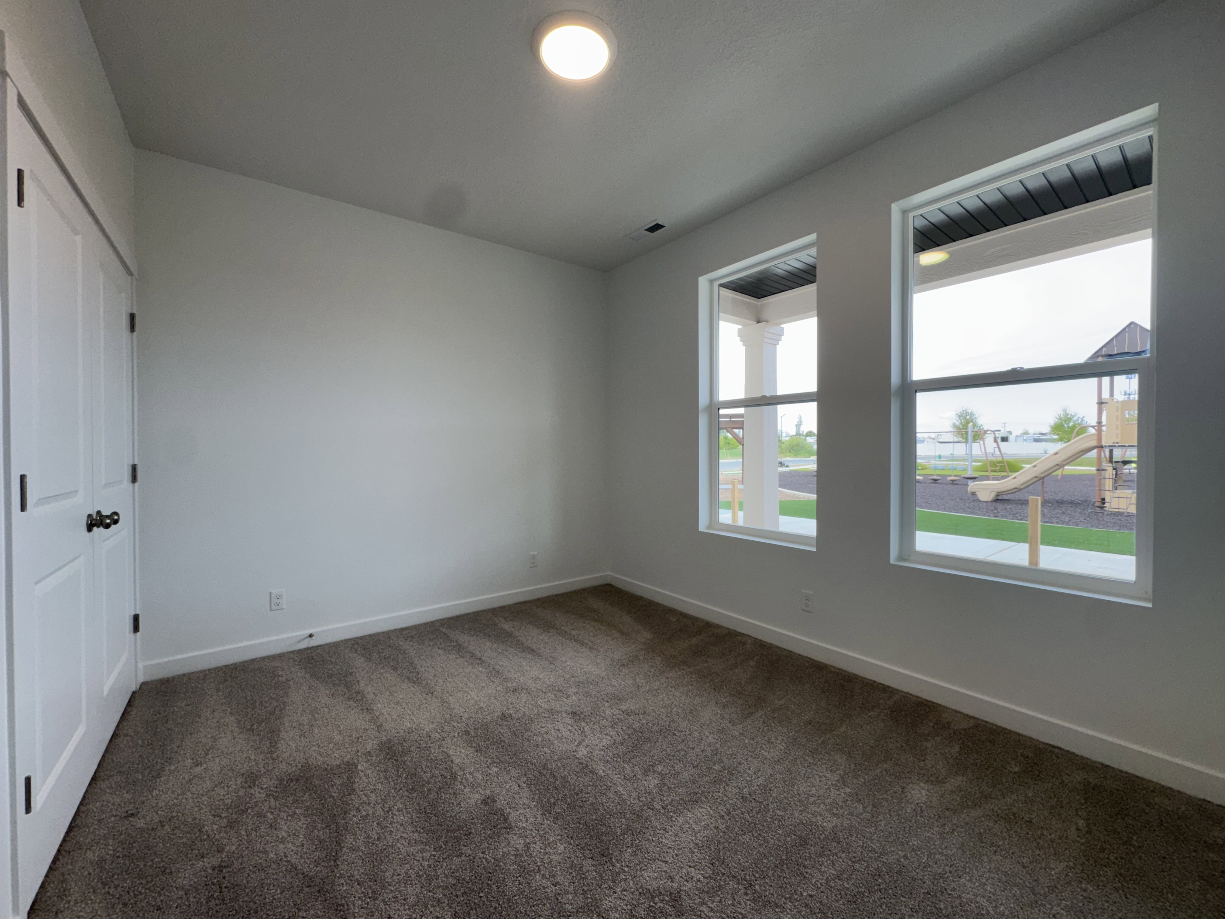 Unfurnished bedroom featuring a closet and dark carpet