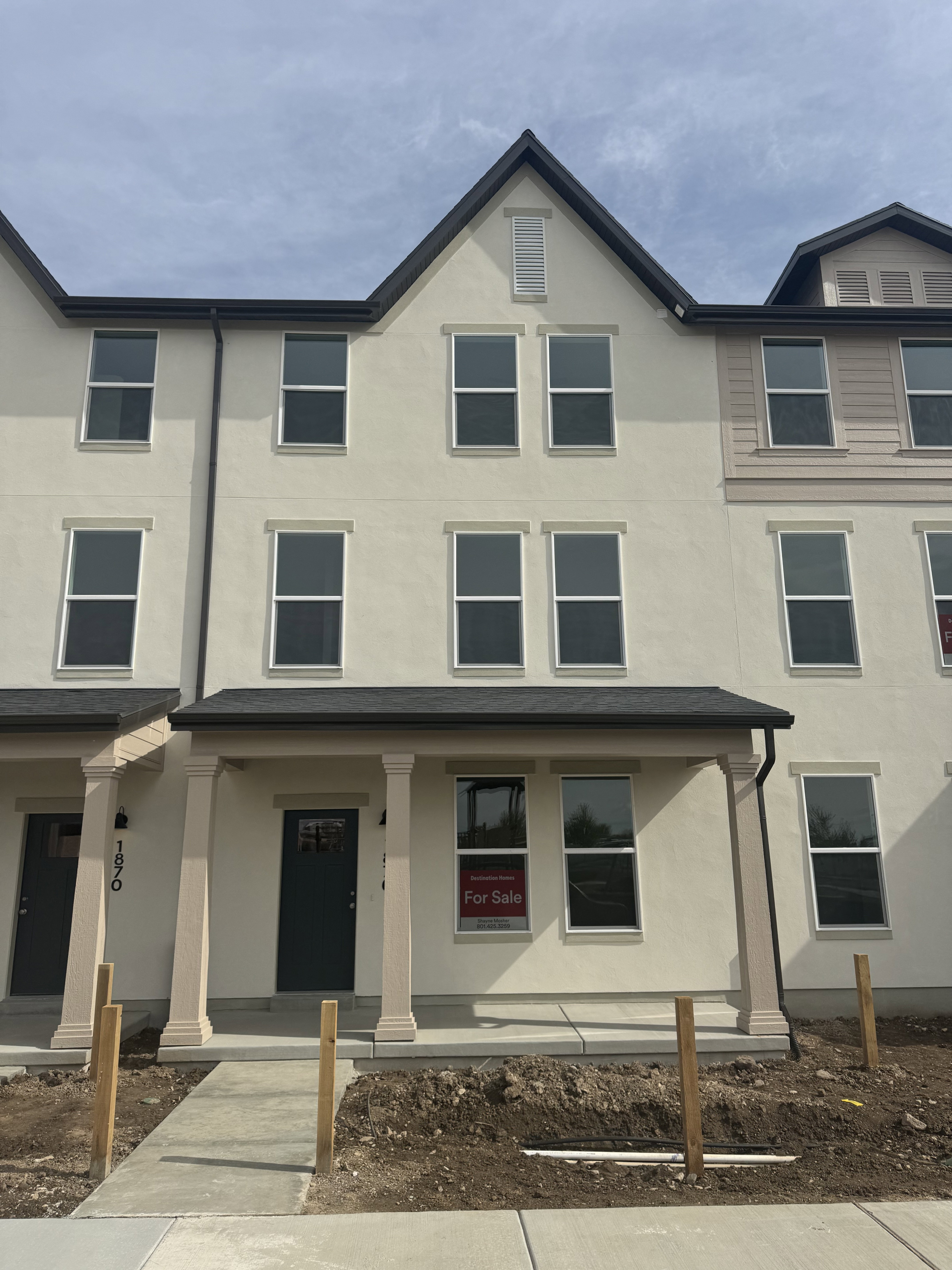 View of front of home featuring covered porch and stucco siding