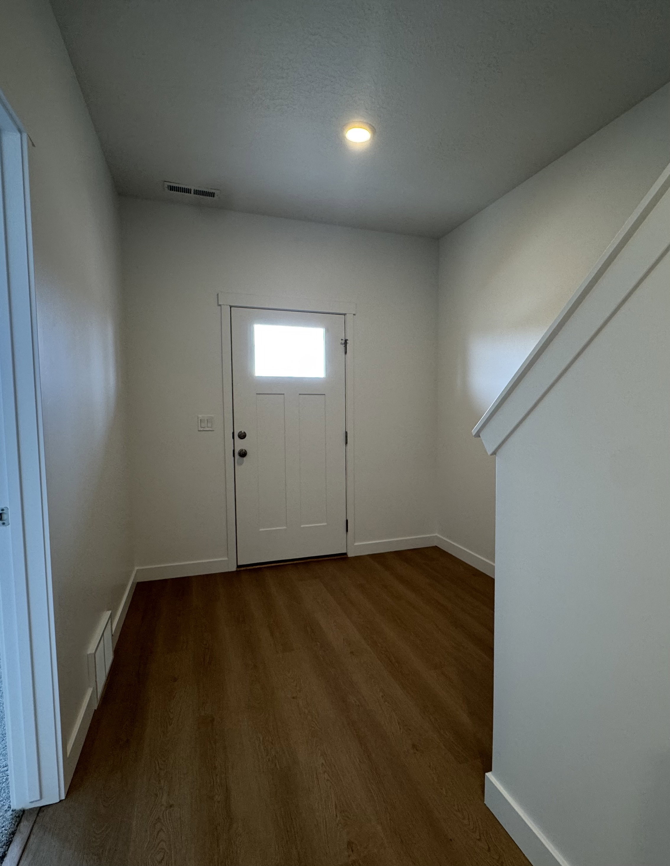 Entryway featuring baseboards and dark wood finished floors
