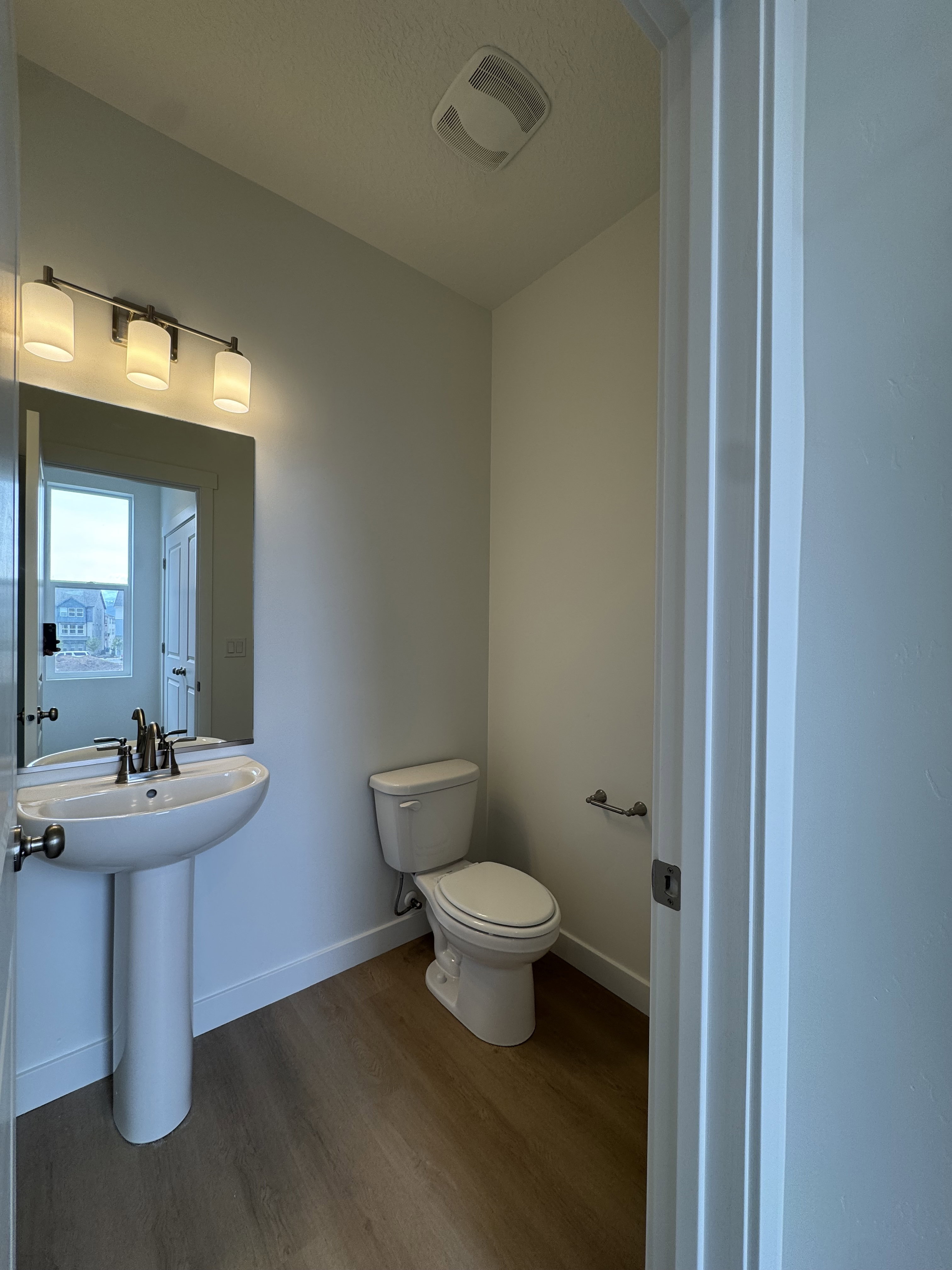 Bathroom featuring dark wood-style floors and a textured ceiling