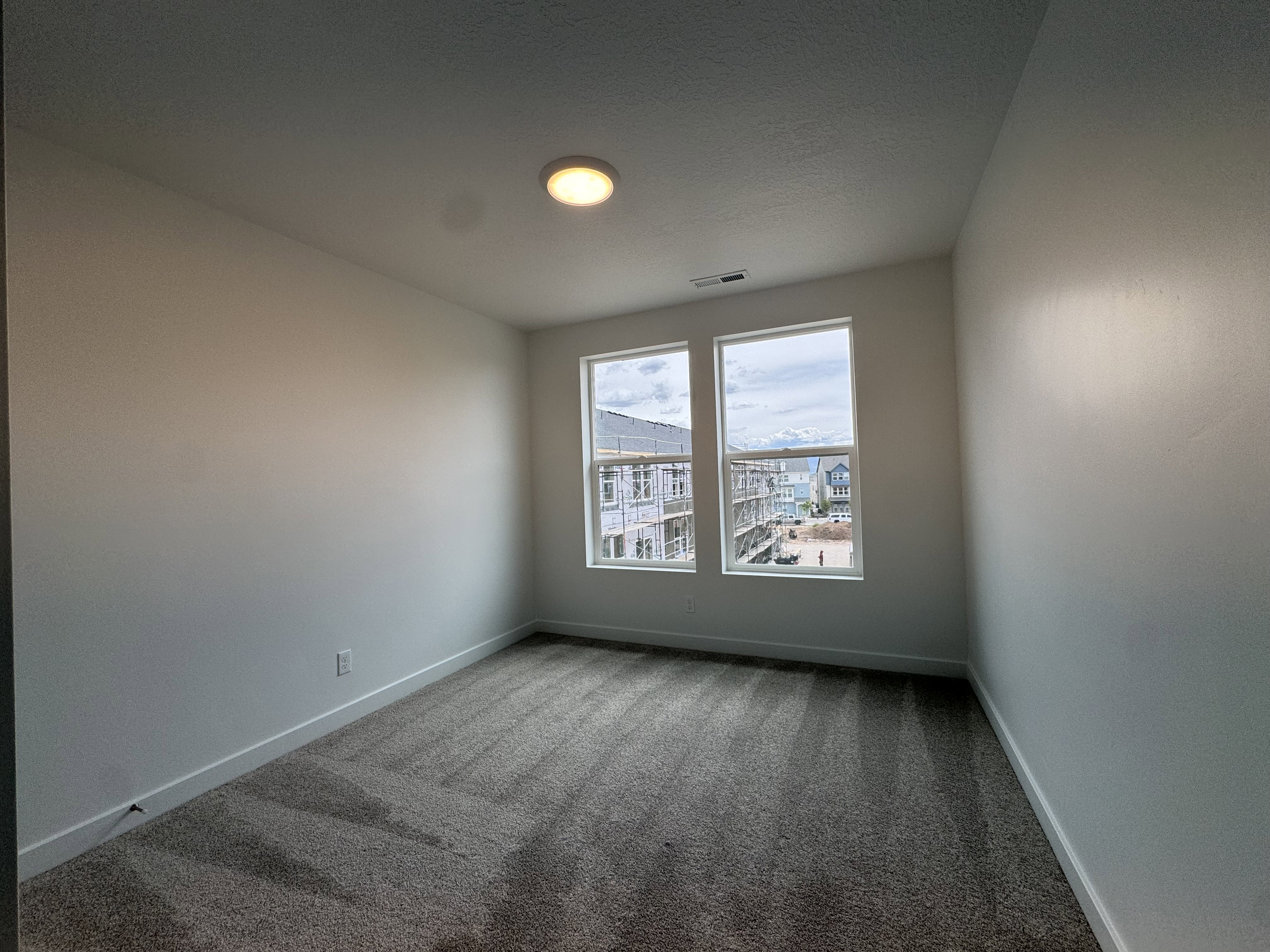 Empty room with carpet flooring and baseboards