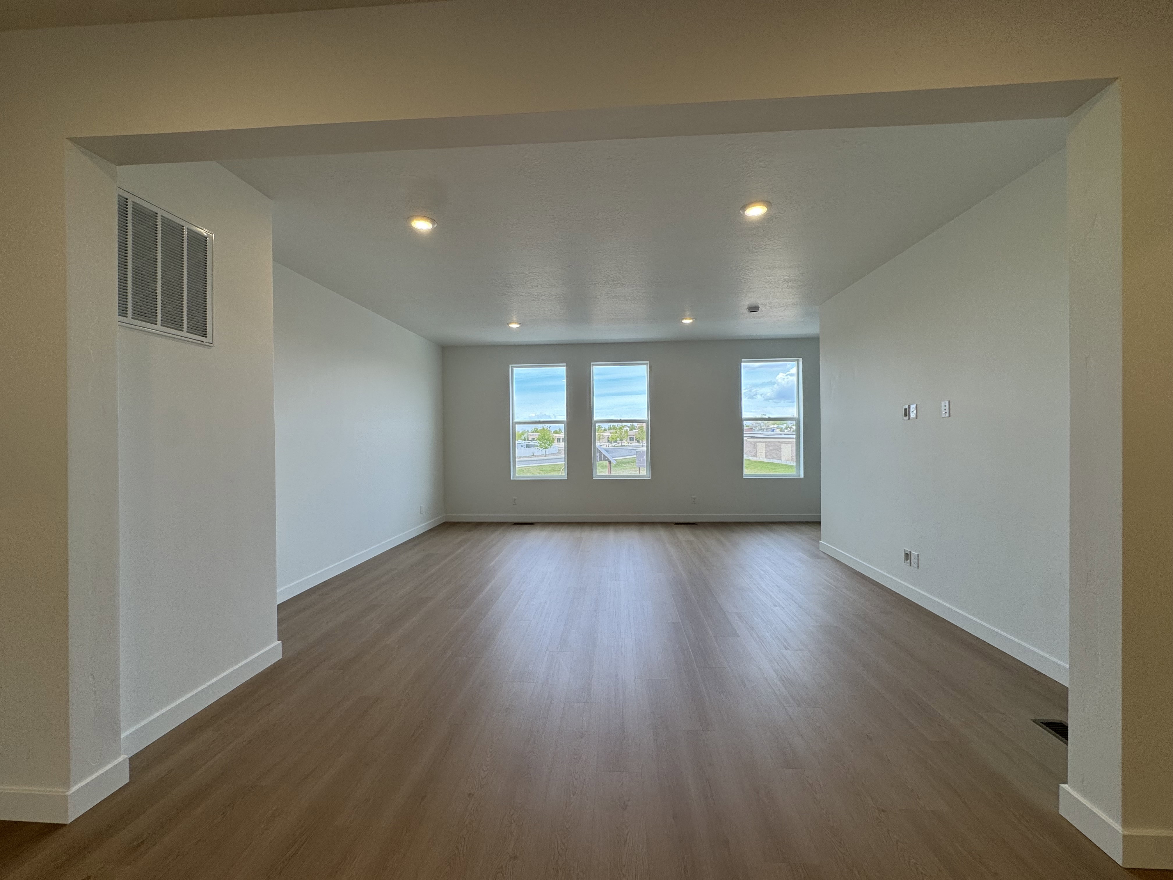 Spare room with dark wood-style floors and recessed lighting