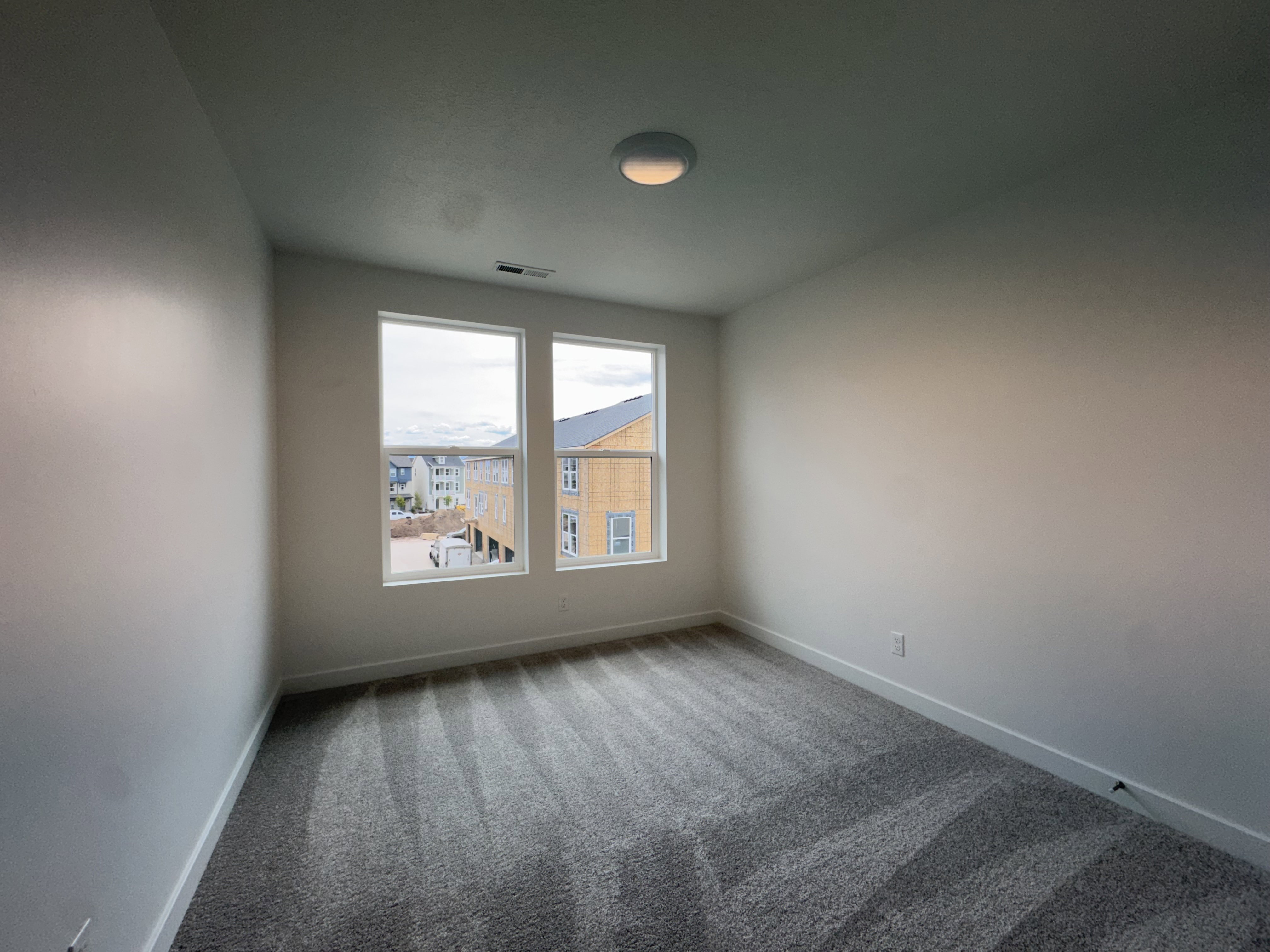 Empty room with carpet floors and baseboards