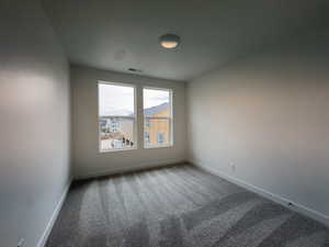 Empty room with carpet floors and baseboards