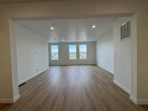 Empty room with recessed lighting and light wood-style flooring
