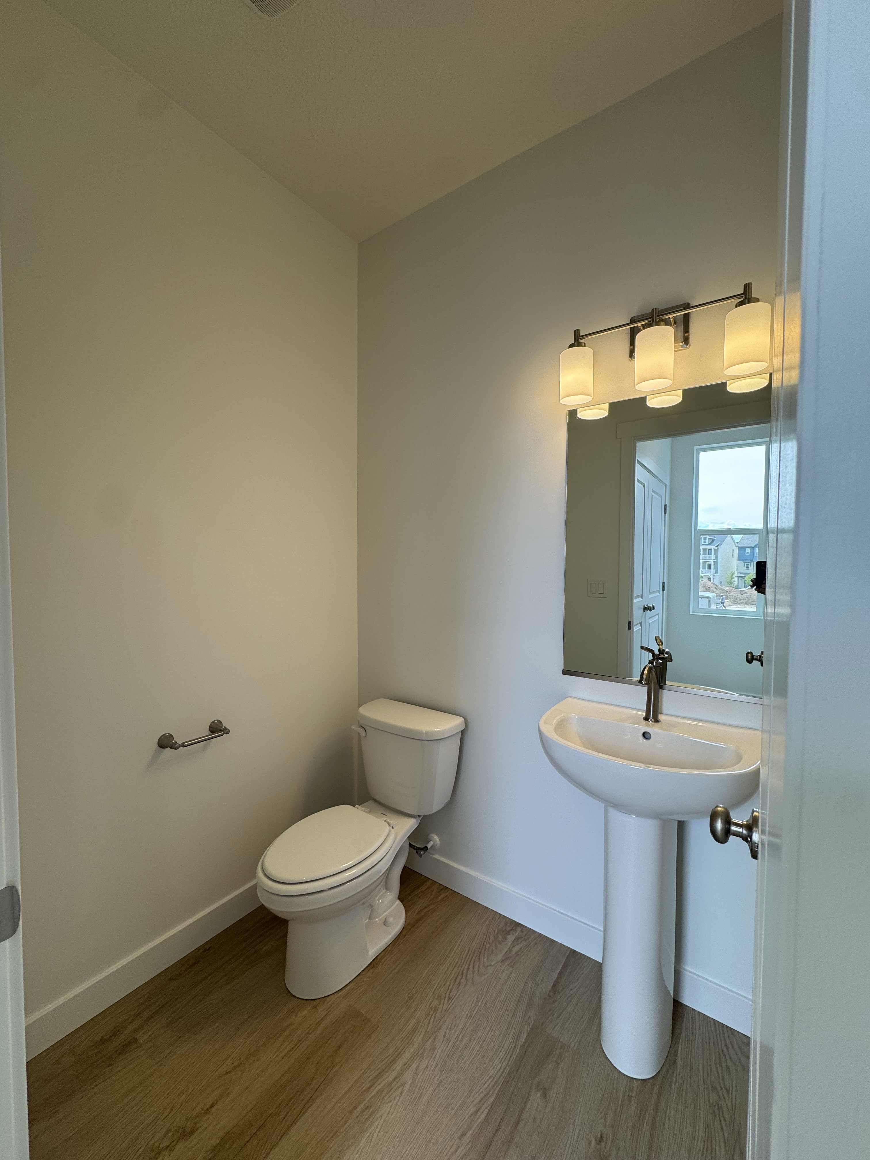 Bathroom with baseboards and wood finished floors