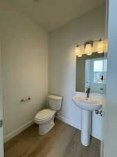 Bathroom with baseboards and wood finished floors