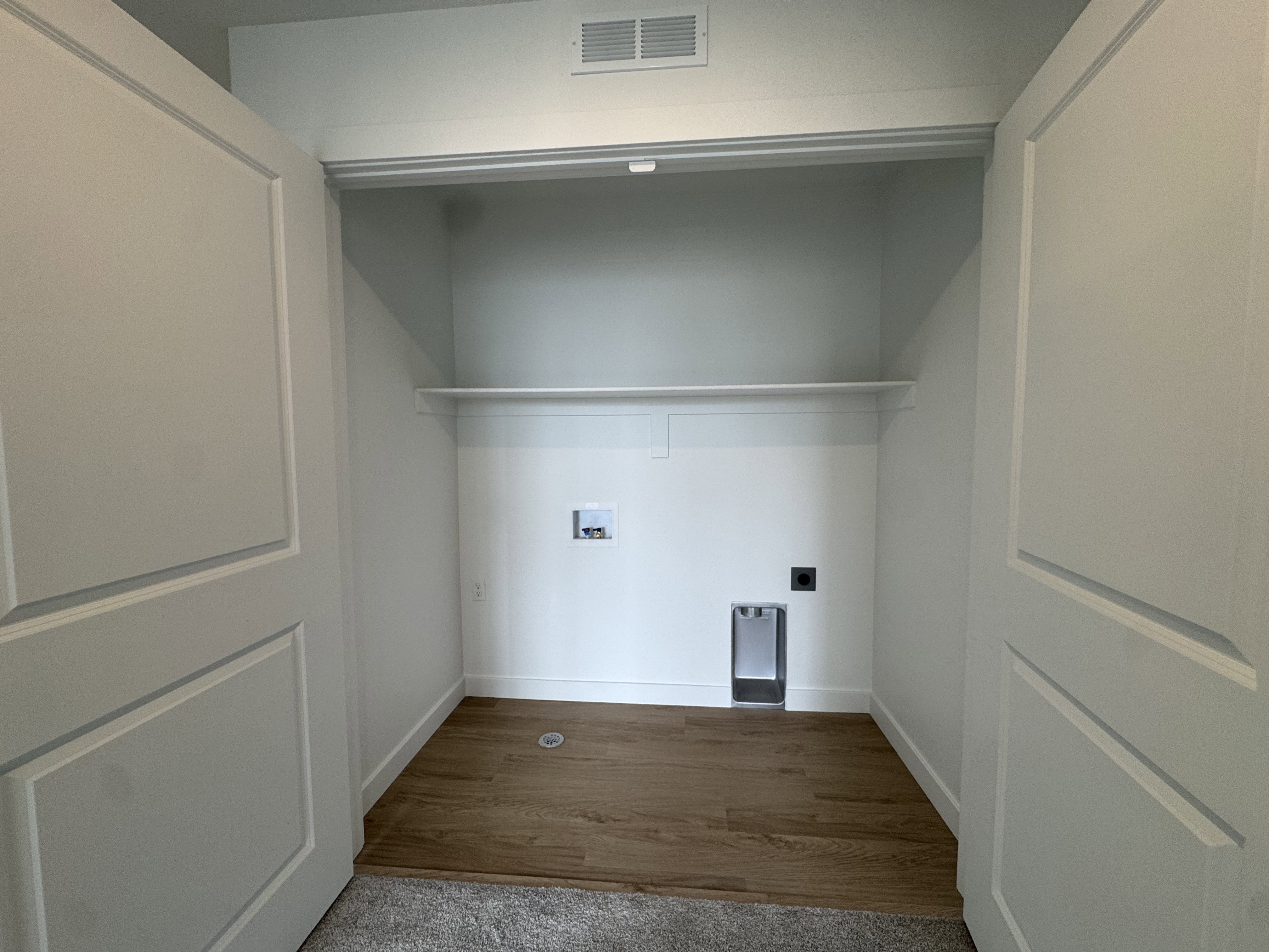 Laundry area featuring electric dryer hookup, washer hookup, and dark wood-style flooring