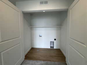 Laundry area featuring electric dryer hookup, washer hookup, and dark wood-style flooring
