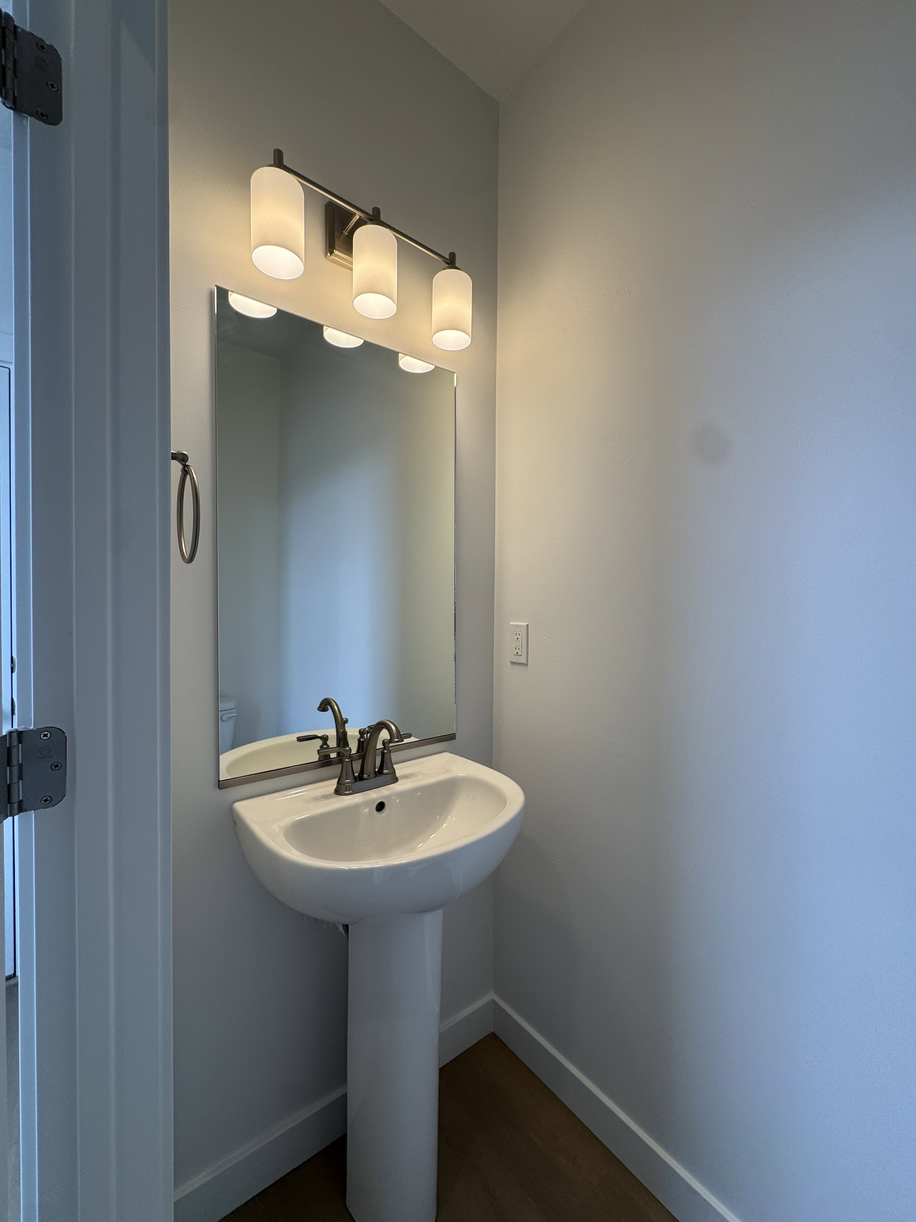 Bathroom featuring baseboards and dark wood finished floors