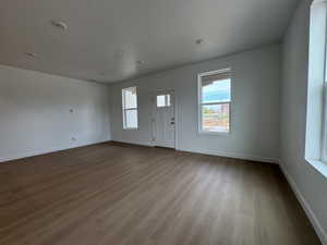 Foyer featuring dark wood finished floors, healthy amount of natural light, and a textured ceiling