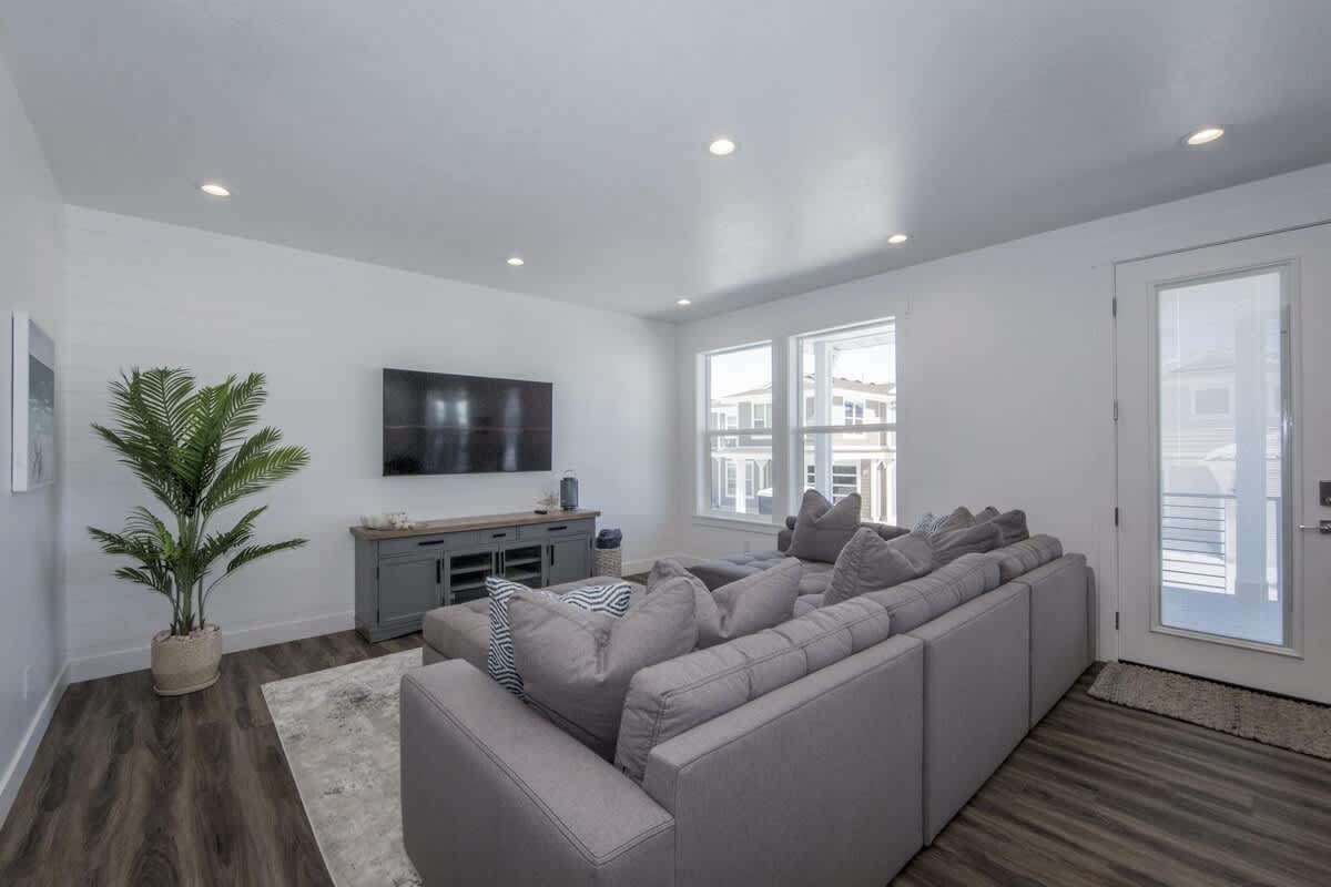 Living room with dark wood-style flooring and recessed lighting