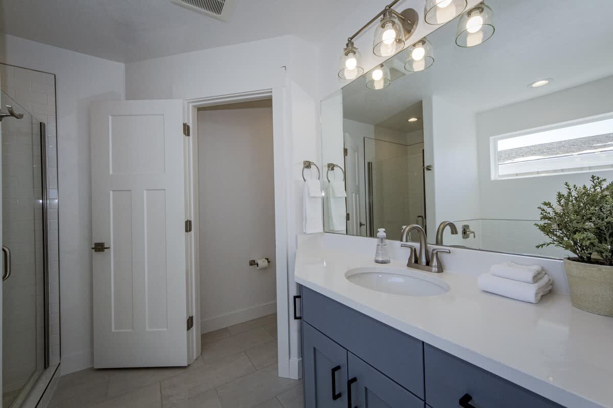 Full bathroom featuring a shower stall, vanity, light tile patterned floors, and recessed lighting