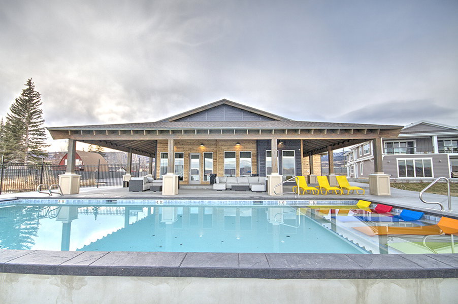 Community pool with outdoor lounge area and a patio area