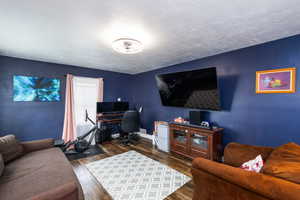 Office featuring dark wood finished floors and a textured ceiling