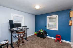 Carpeted home office with baseboards