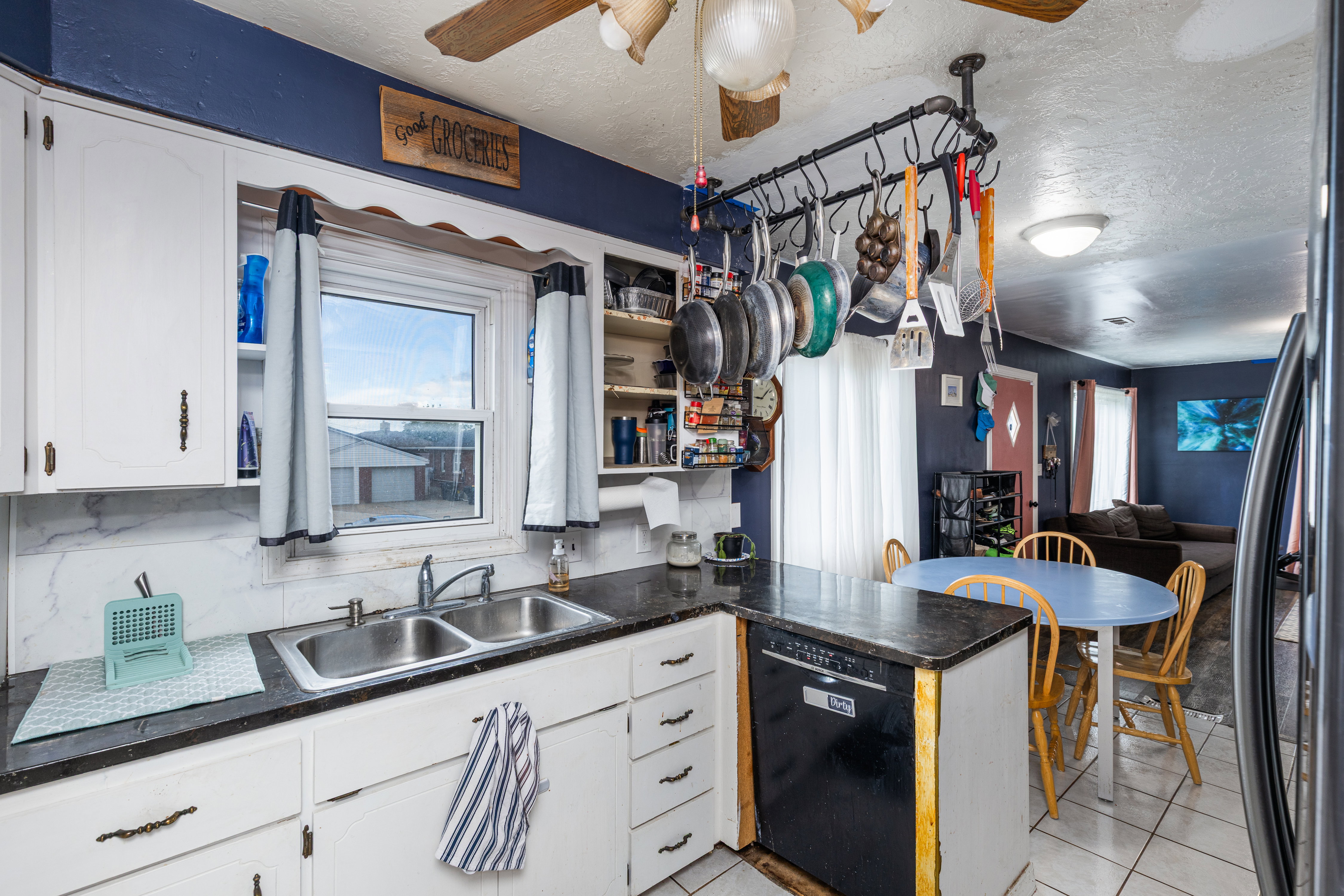 Kitchen featuring dark countertops, white cabinetry, a peninsula, a textured ceiling, and ceiling fan