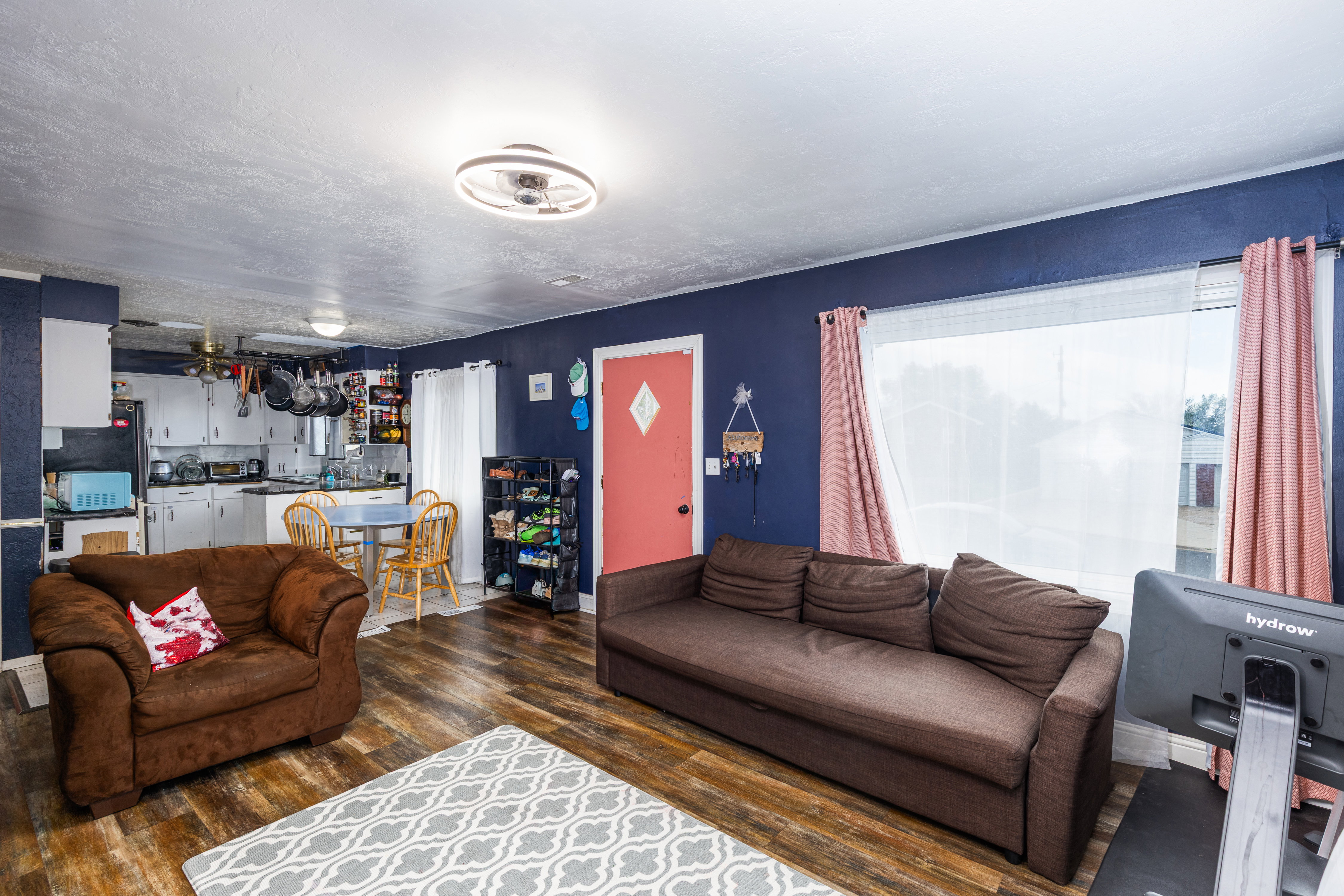 Living area featuring dark wood finished floors and ceiling fan