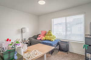 Carpeted bedroom featuring baseboards