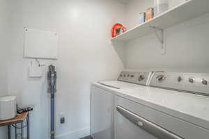 Laundry room with separate washer and dryer and baseboards