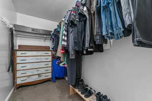 Walk in closet with carpet floors