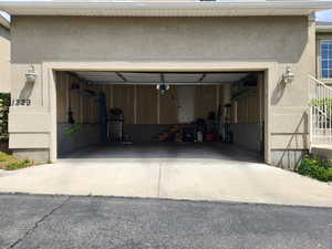 Garage featuring concrete driveway