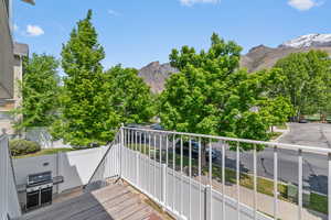Wooden deck with a mountain view and area for grilling
