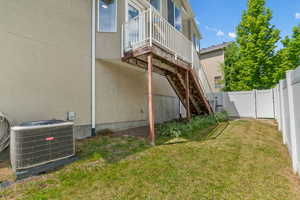 Rear view of property with a fenced backyard and stucco siding