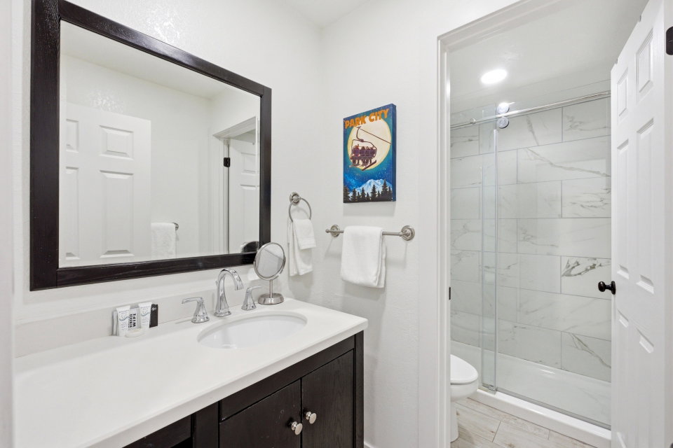 Full bathroom with vanity and a marble finish shower