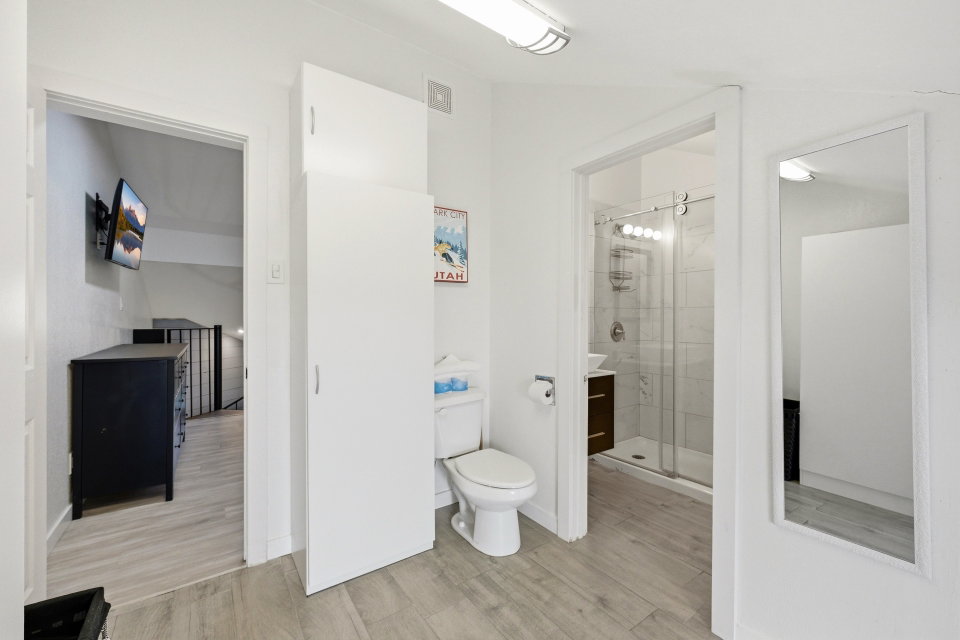 Bathroom featuring a shower stall, light wood-style floors, and vanity