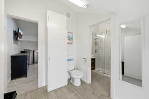 Bathroom featuring a shower stall, light wood-style floors, and vanity