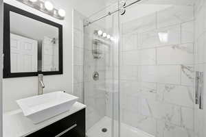 Bathroom with a stall shower and vanity