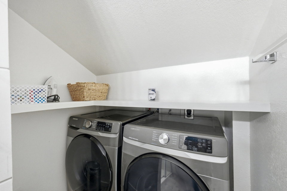 Laundry area with washing machine and clothes dryer
