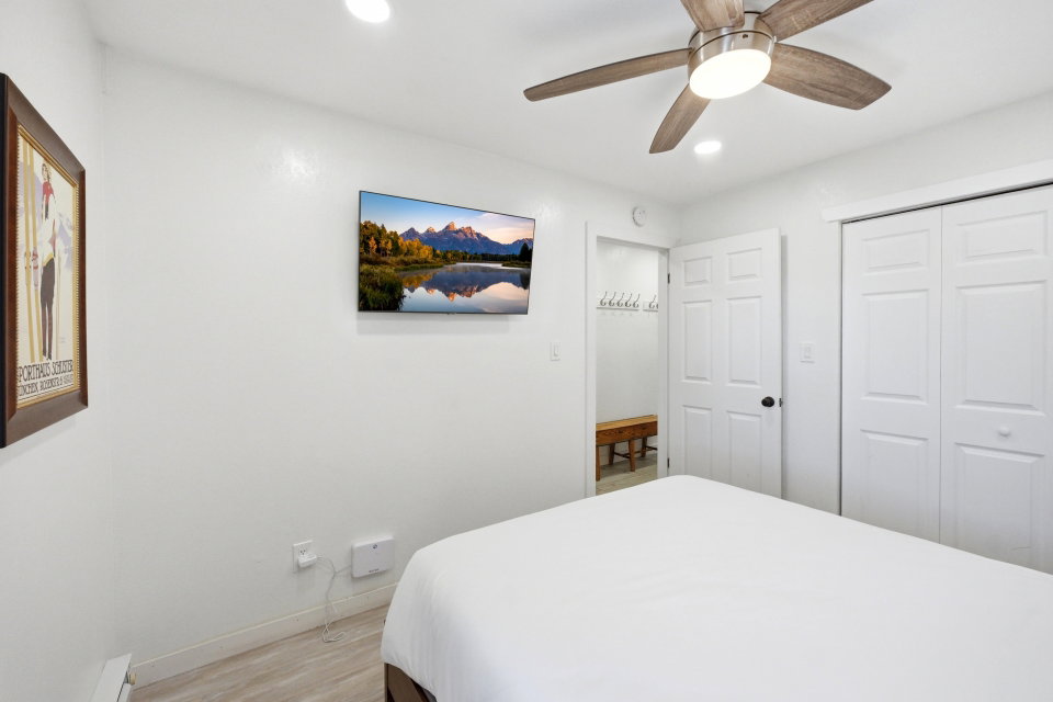 Bedroom with light wood-style floors, a ceiling fan, a closet, and recessed lighting