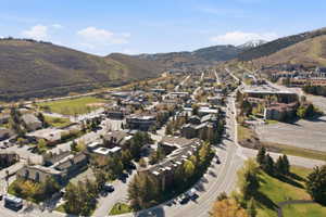 View of property location with mountains and nearby suburban area