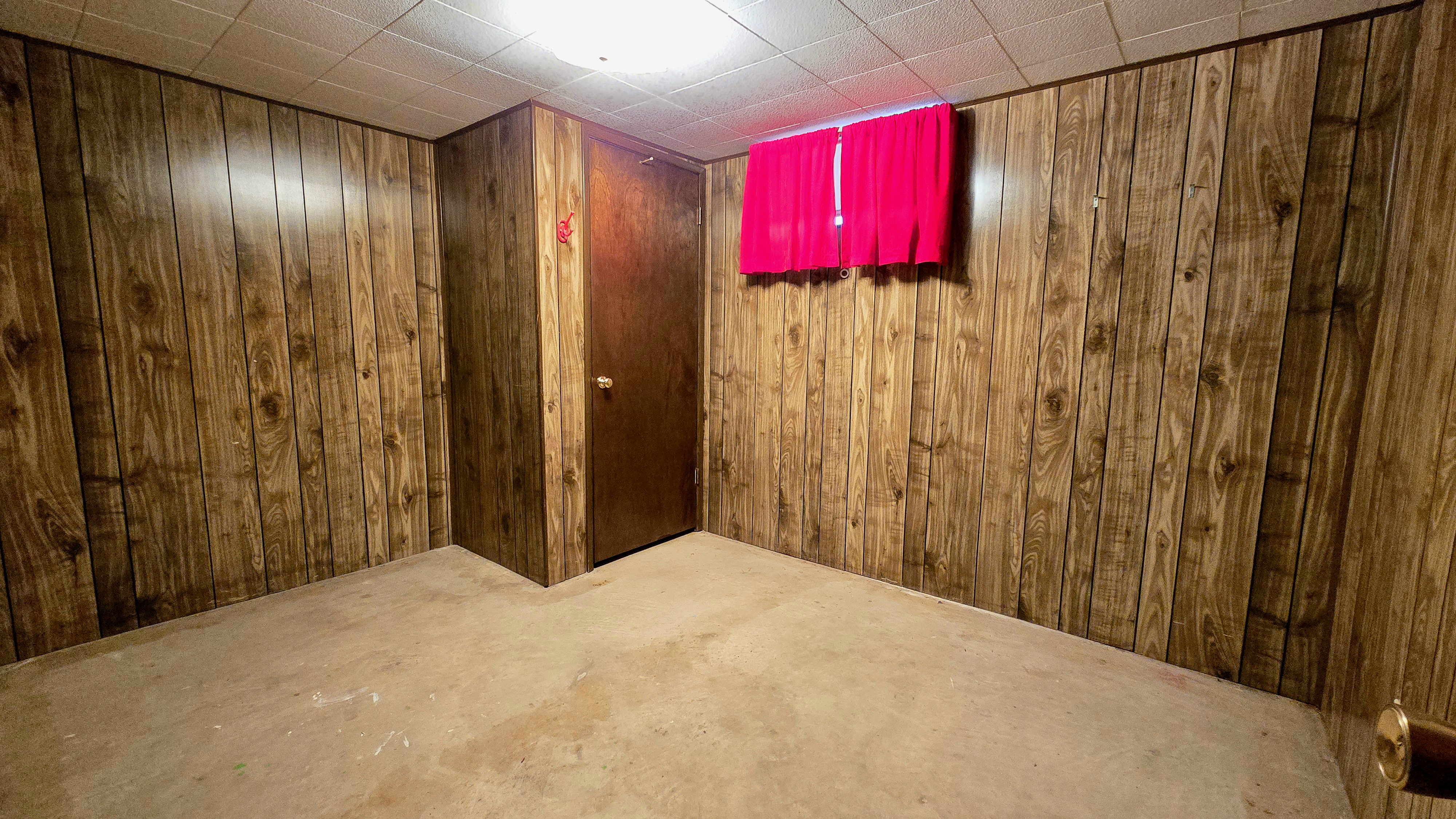 Finished below grade area featuring wooden walls