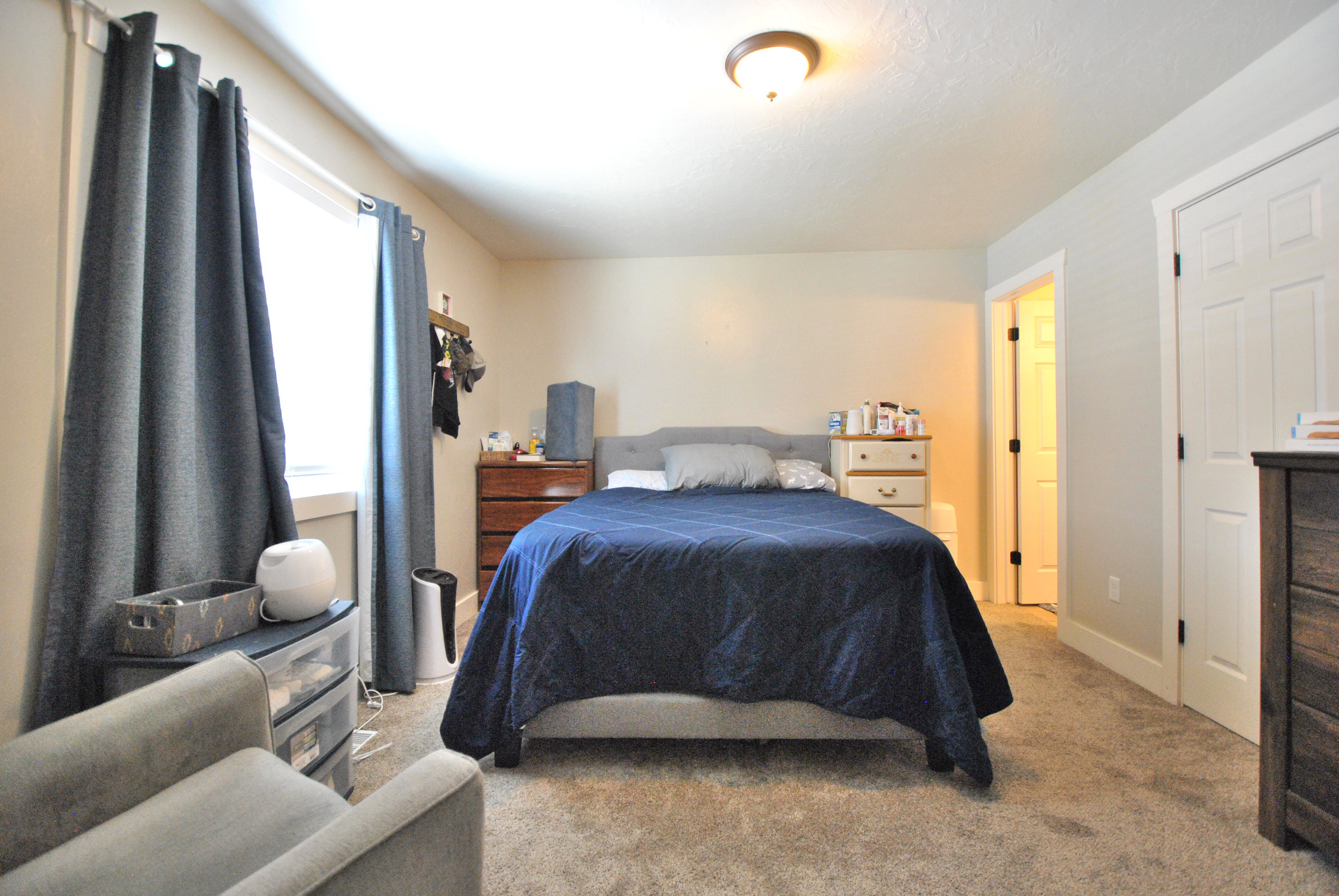 Primary bedroom featuring carpeted floors, and baseboards