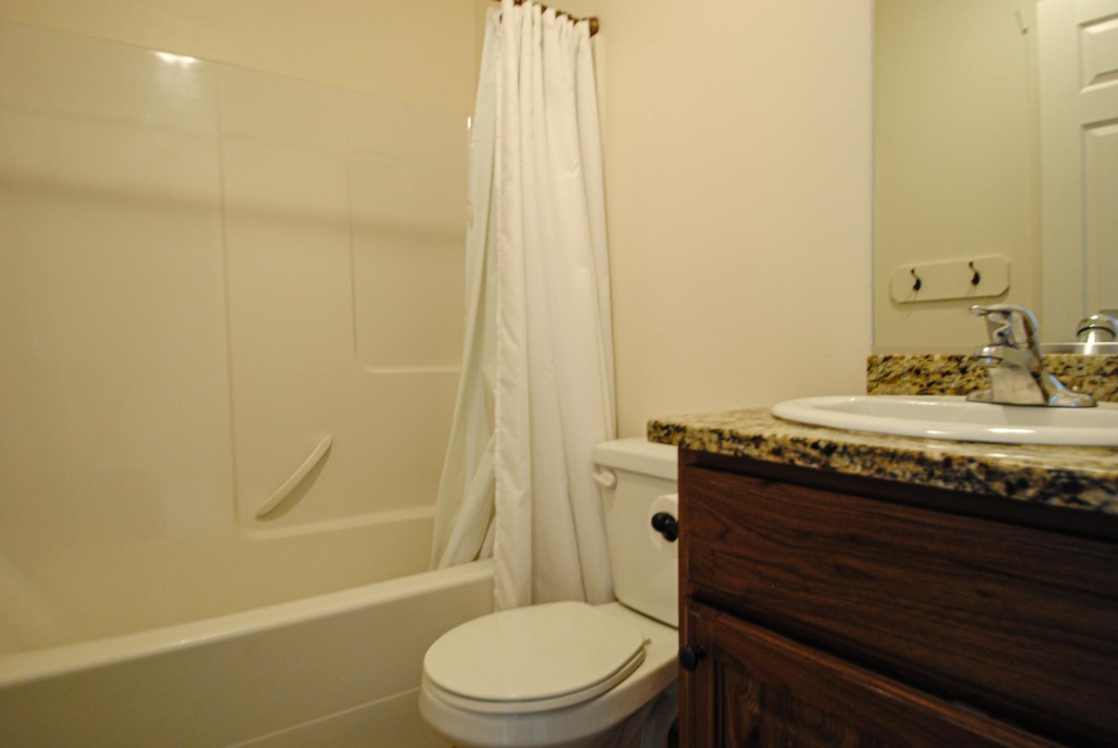Full bath with vanity and shower / bath combo