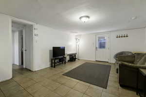 Living room featuring light tile patterned floors and baseboards