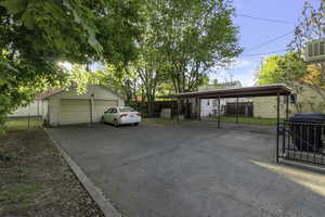 View of parking featuring a detached garage