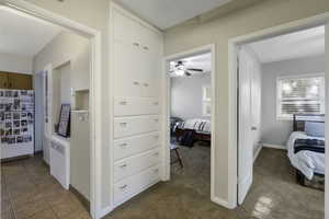 Corridor with radiator, light carpet, and plenty of natural light