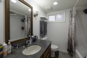 Full bathroom with vanity and shower / bath combo with shower curtain